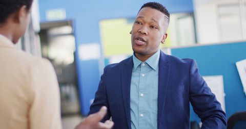 Diverse Professionals Engaging in Office Discussion