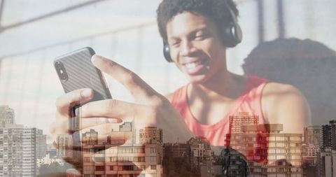 Joyful African American Man with Headphones Overlooking Cityscape - Download Free Stock Images Pikwizard.com