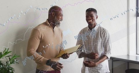 Manager mentoring junior and analyzing financial charts for business growth