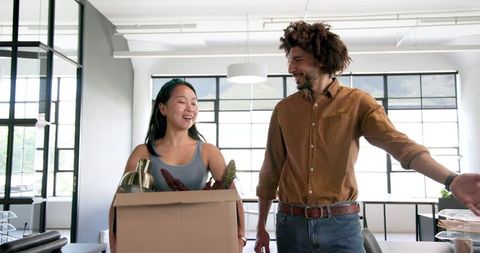 Diverse Coworkers Unpacking Office Supplies Together
