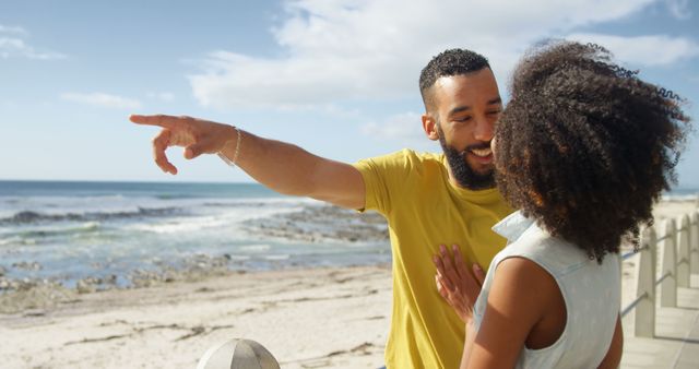 Happy Couple Enjoying Beach Vacation, Man Pointing with Excitement - Download Free Stock Images Pikwizard.com