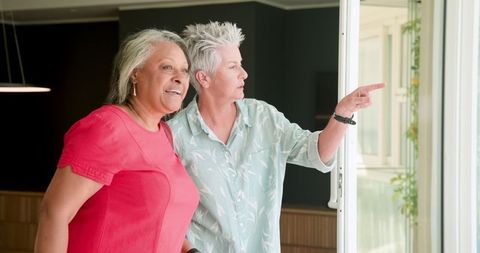 Senior Lesbians Enjoying Scenic Hotel View Together