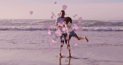 Father Spinning Daughter on Beach at Sunset with Floating Heart Effects