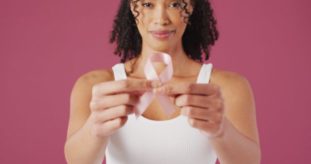 Woman Holding Pink Breast Cancer Awareness Ribbon on Pink Background - Download Free Stock Images Pikwizard.com