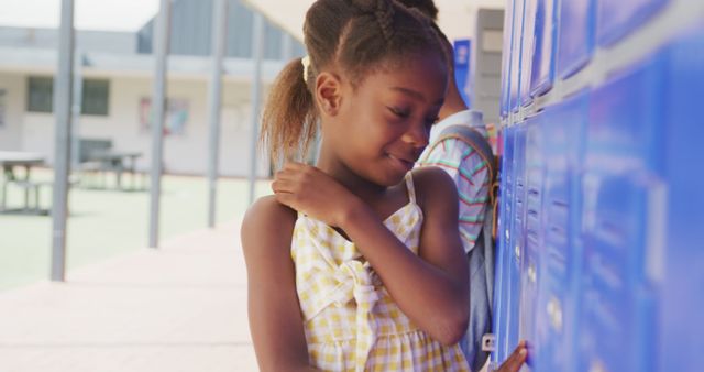 Smiling Girl in Schoolyard Opening Locker - Download Free Stock Images Pikwizard.com