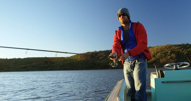 Caucasian man enjoys fishing on a serene lake, with copy space - Download Free Stock Photos Pikwizard.com
