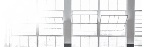 Transparent glass windows in brightly lit modern office space