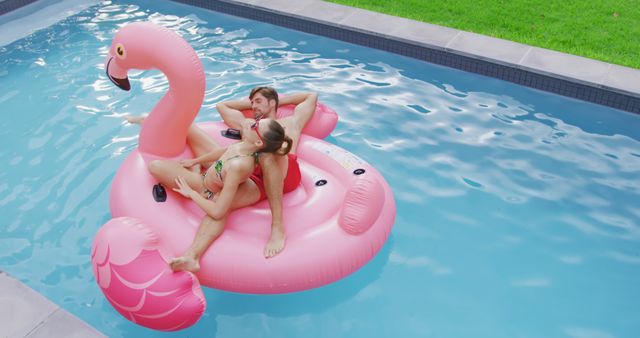 Couple Relaxing on Flamingo Pool Float on Sunny Day - Download Free Stock Images Pikwizard.com