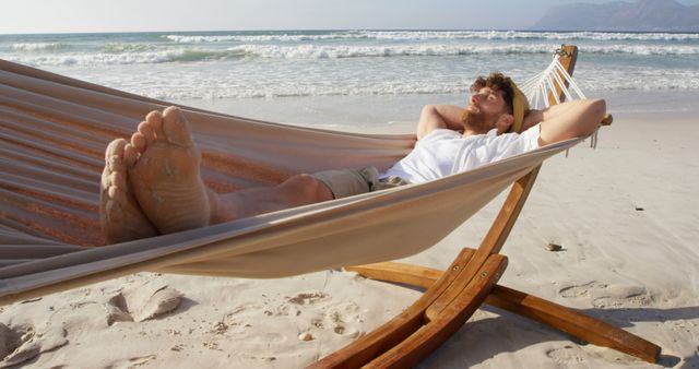 Man Relaxing in Hammock on Sandy Beach - Download Free Stock Images Pikwizard.com