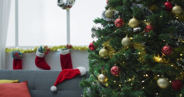 Image of christmas greetings, decorations, christmas tree, lights and christmas stockings at home. christmas, tradition and celebration concept.