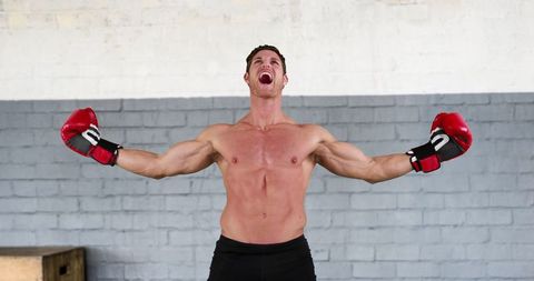 Triumphant Boxer Celebrating Victory in Boxing Gym