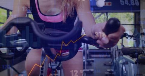 Female cyclist pedaling spin bike with performance metrics overlay for cardio training