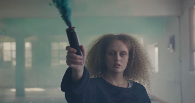 Young Woman Holding Smoke Bomb in Abandoned Building - Download Free Stock Images Pikwizard.com