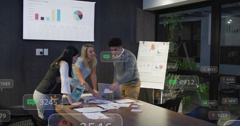 Team collaborating with augmented reality data overlays in modern office meeting room