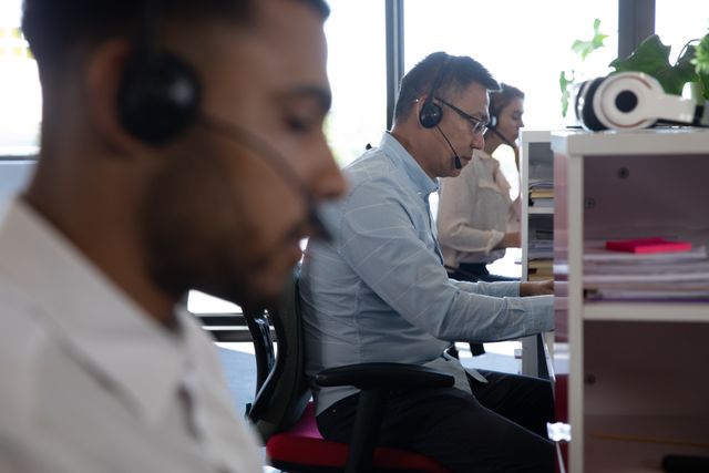 Business Team Wearing Headsets Working in Modern Office - Download Free Stock Images Pikwizard.com