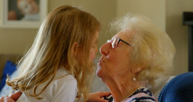 Grandmother Kissing Young Granddaughter at Home - Download Free Stock Images Pikwizard.com