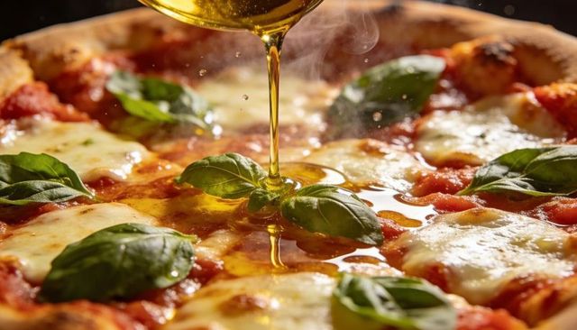 Drizzling olive oil over margherita pizza with fresh basil and melted mozzarella