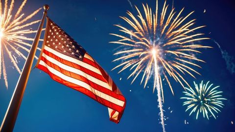American flag with vibrant fireworks lighting night sky