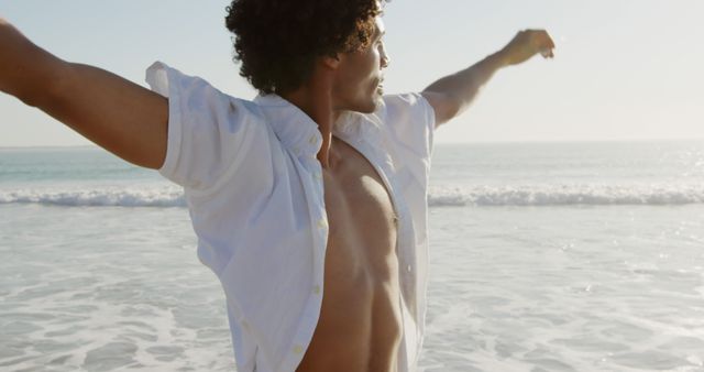 Carefree Man with Outstretched Arms Savoring Beach vVew - Download Free Stock Images Pikwizard.com