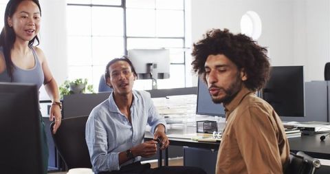 Diverse team having collaborative discussion in modern office