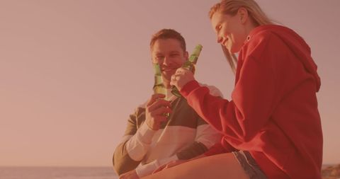 Couple Enjoying Beers During Beach Sunset