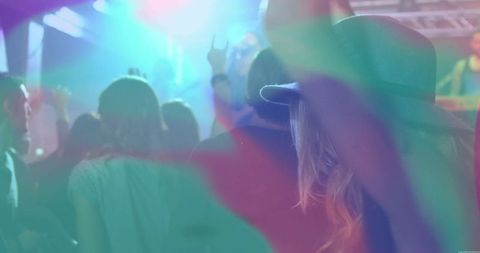 Energetic crowd at vibrant music concert with flare lighting