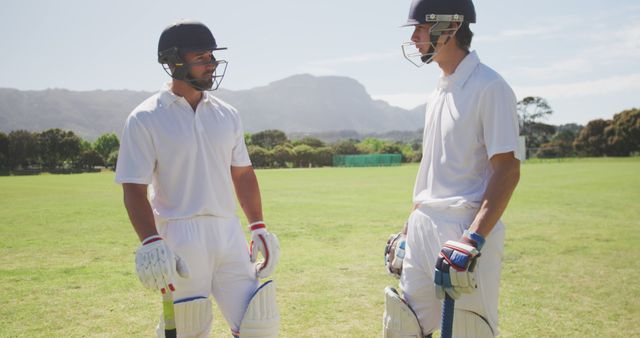 Two Male Cricketers Discussing Strategy During Game on Sunny Day - Download Free Stock Images Pikwizard.com