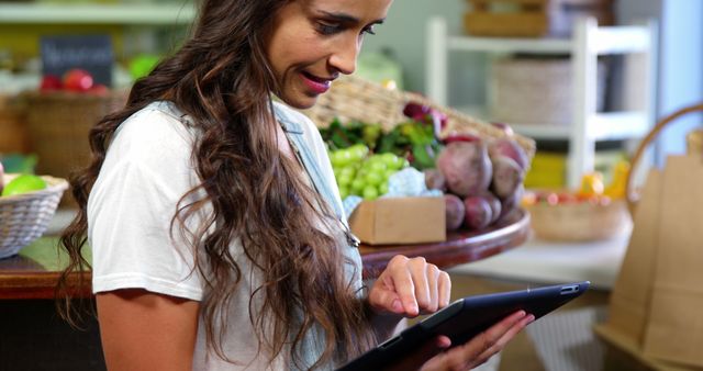 Woman using digital tablet in organic market