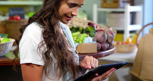 Woman using digital tablet in organic market - Download Free Stock Photos Pikwizard.com