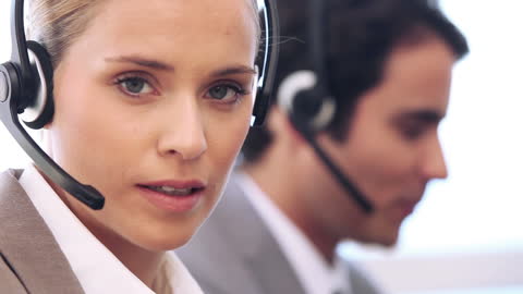 Customer Service Professional Using Headset in Modern Office