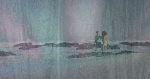 Couple enjoying walk on rocky beach during low tide