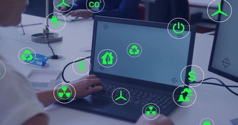 Typing woman using laptop displaying floating green sustainability icons in coworking workspace
