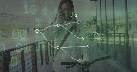 Man Pushing Bicycle While Engaging with Smartphone Technology