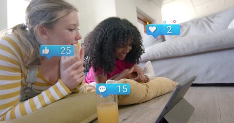 Teen girls engaged with social media on tablet