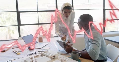 Architects Collaborating on Innovative Design Project in Sunlit Office