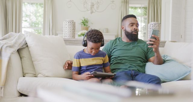 Father and Son Relaxing at Home with Digital Devices - Download Free Stock Images Pikwizard.com