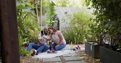 Joyful Couple Enjoying Picnic in Verdant Garden Paradise