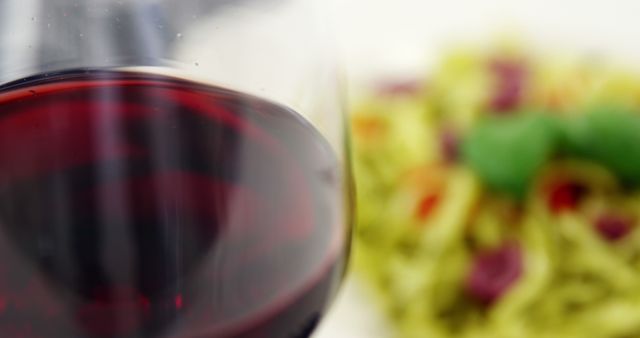 Close-Up of Red Wine Glass and Colorful Pasta Dish - Download Free Stock Images Pikwizard.com