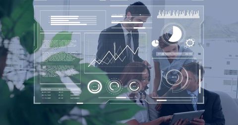 Business team analyzing interactive data overlay while collaborating over tablet in office