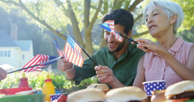 Happy Family Waving American Flags at Outdoor Picnic - Download Free Stock Images Pikwizard.com