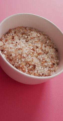 Coarse Flavored Salt in White Bowl on Pink Background