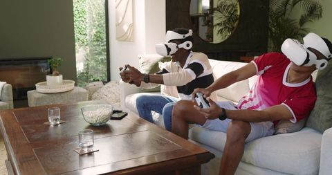 Two Friends Gaming with VR Headsets in Modern Living Room