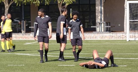 Soccer players celebrating on field with fist pump gesture