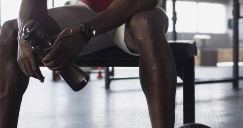 Athlete Relaxing with Water Bottle Post Workout