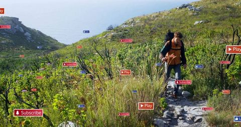 Male hiker on coastal trail with social media icons floating