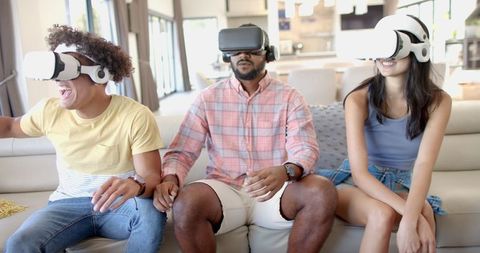 Group of Friends Enjoying Virtual Reality in Modern Living Room