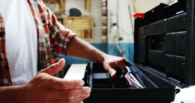 Man Adjusting Toolbox in Workshop - Download Free Stock Images Pikwizard.com