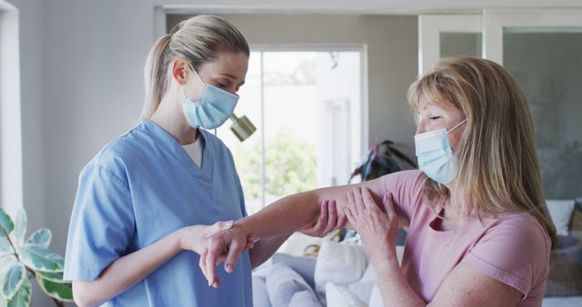 Healthcare Worker Assessing Elderly Woman's Elbow at Home - Download Free Stock Images Pikwizard.com