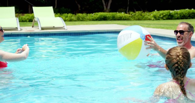 Family Enjoying Fun Pool Day with Beach Ball - Download Free Stock Images Pikwizard.com