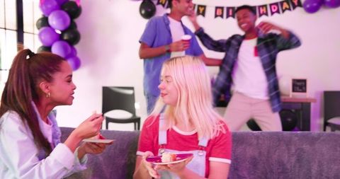 Diverse Friends Celebrating Birthday with Dance and Cake Indoors